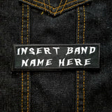 White on black rectangular embroidered patch that says insert band name here.