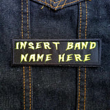 Yellow on black rectangular embroidered patch that says insert band name here.