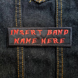 Red on black rectangular embroidered patch that says insert band name here.