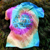 Pastel tie-dyed t-shirt in a women's v-cut printed in multicolor lettering that says as weird as the day is orange.