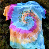 Pastel tie-dyed t-shirt printed in multicolor lettering that says as weird as the day is orange.