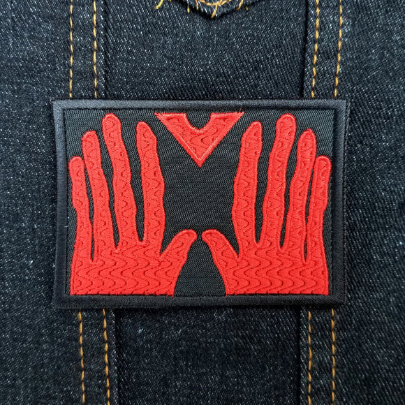 Red on black embroidered patch of red hands from the cult classic b movie, manos, the hands of fate.