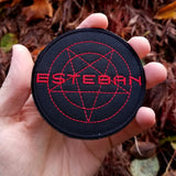Embroidered patch from the movie Evil Speak, showing the name Esteban in red thread over a pentagram. Shown in a hand for size reference.