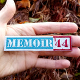 Memoir 44 boardgame logo embroidered patch. Shown in the palm of a hand for size reference.