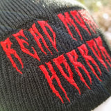 Black knit beanie with the words read more horror embroidered in creepy red lettering.