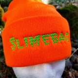 Bright orange knit beanie with the word slimebag embroidered in green slimy-looking letters.
