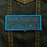 Blue on black embroidered logo patch for the classic board game Race for the Galaxy.