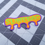 Neon green and purple on bright orange embroidered patch with the word, slimebag, and a oozing shaped border design.