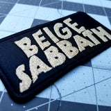 Rectangular tan on black embroidered patch with the words beige sabbath in the logo style of the classic rock band black sabbath.