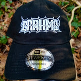 Black baseball cap with a heavy metal style logo for the classical music composer Brahms embroidered on the front in white thread.