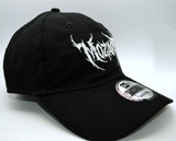 Right side view of a black baseball hat with a heavy metal style logo for the classical music composer Mozart embroidered on the front in white thread.