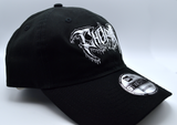 Left side view of a black baseball hat with a heavy metal style logo for the classical music composer Chopin embroidered on the front in white thread.