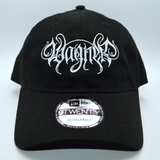 Front view of a black baseball cap with a heavy metal style logo for the classical music composer Wagner embroidered on the front in white thread.