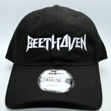 Front view of a black baseball hat with a heavy metal style logo for the classical music composer Beethoven embroidered on the front in white thread.
