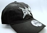 Right side view of a black baseball hat with a heavy metal style logo for the classical music composer Bach embroidered on the front in white thread.