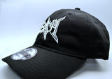 Left side view of a black baseball hat with a heavy metal style logo for the classical music composer Bach embroidered on the front in white thread.