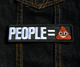 Rectangular black embroidered patch with that says people equals in white lettering followed by the poop emoji. Shown on a denim jacket.