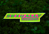 A narrow, sharp angled embroidered patch that says sexually mediocre in bright neon green, pink, and yellow colors.