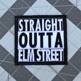Square black and white embroidered patch that says straight outta elm street.