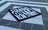 Close up detail of a square black and white embroidered patch that says straight outta elm street.