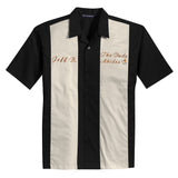 Black and stone colored bowling shirt inspired by The Big Lebowski, with the quote the dude abides embroidered on the left chest with a white russian cocktail and a custom name personalization embroidered on the right chest.