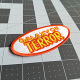 Yellow and orange on white embroidered patch of the title logo for the classic b horror and sci-fi movie Galaxy of Terror.