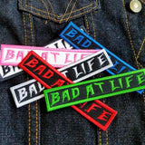 Bad At Life embroidered patch in multiple colors.