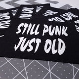 White on black screen printed canvas patch that says still punk, just old.