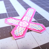 Inverted cross embroidered patch with hot pink and multicolor thread.