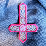 Inverted crucifix embroidered patch with hot pink and multicolor thread.