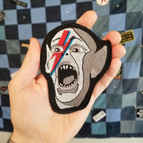 Embroidered patch of the Bat Boy wearing David Bowie makeup from Alladin Sane.