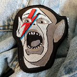Embroidered patch of the Bat Boy wearing David Bowie makeup from Alladin Sane.