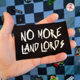 A white on black screen printed canvas patch that says no more landlords in graffiti lettering.