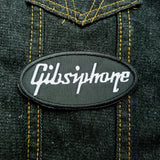 White on black Gibsiphone embroidered patch, a parody mashup of Gibson and Epiphone guitars.