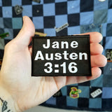 Jane Austen three sixteen embroidered patch, shown in the palm of a hand for size reference.