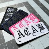 A collection of ACAB embroidered patches in multiple colors.