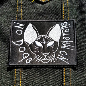 White on black embroidered patch of a cat that says no dogs, no masters.