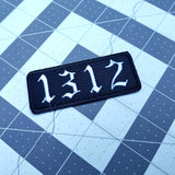 1312 embroidered patch in an old English font, white lettering on black material.