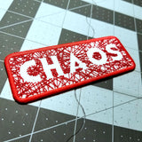 Close up detail of a red on white embroidered patch with hundreds of  random lines of thread spelling the word chaos.