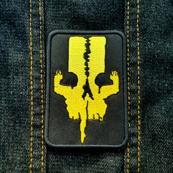 Yellow on black embroidered logo patch for the adventure boardgame The 7th Continent.