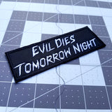 Embroidered patch reading evil dies tomorrow night, in reference to Halloween Kills.