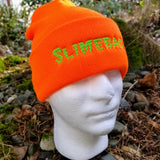 Bright orange knit beanie with the word slimebag embroidered in green slimy-looking letters.