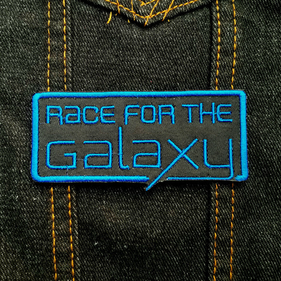 Blue on black embroidered logo patch for the classic board game Race for the Galaxy.