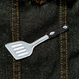 Small embroidered patch of a spatula.