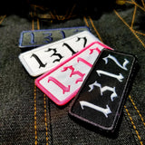 A collection of variously-colored rectangular embroidered patches with the number 1312.