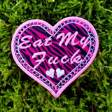 A heart-shaped embroidered Valentines patch with black and pink leopard print, white lace border, and the words eat my fuck.