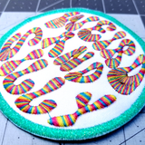 Close up detail of a circular embroidered patch with a bright green border, white background, and the words weird and silly in groovy rainbow lettering.