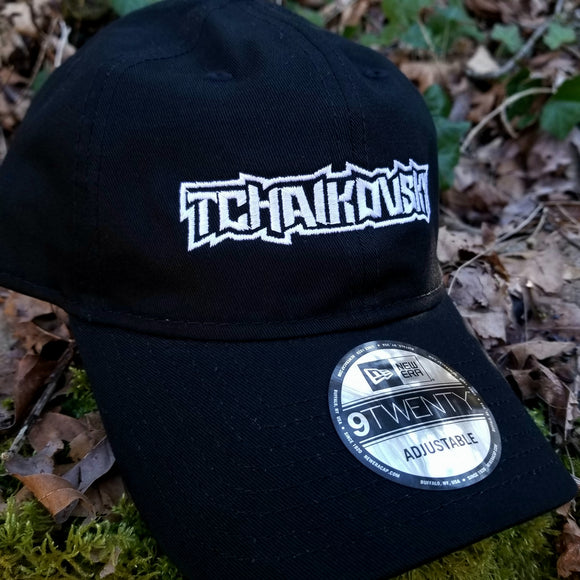 Black baseball cap with a heavy metal style logo for the classical music composer Tchaikovsky embroidered on the front in white thread.