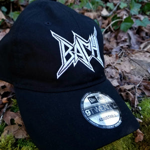 Black baseball cap with a heavy metal style logo for the classical music composer Bach embroidered on the front in white thread.