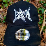 Black baseball cap with a heavy metal style logo for the classical music composer Bach embroidered on the front in white thread.